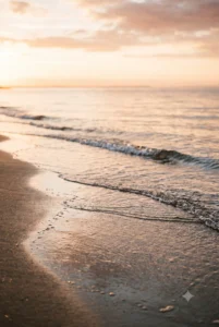 Mare calmo all'alba, onde che vanno e vengono sulla riva: metafora delle fasi del lutto