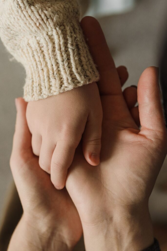 La mano di un bambino nella mano di un adulto: sostegno nel lutto infantile